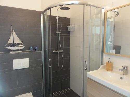 a bathroom with a shower and a sink at Benny's Beach House 2 in Zandvoort