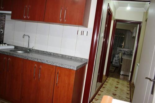 a kitchen with a sink and a counter top at Bandirma Saglik Apart in Bandırma