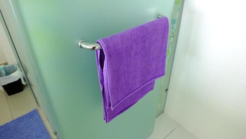 a purple towel hanging on a door in a bathroom at Tranquil Studio @ Trefoil Setia Alam in Shah Alam