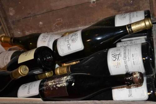 a group of bottles of wine in a drawer at Trattoria Del Bivio in Cerretto Langhe