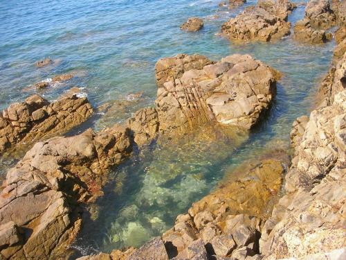 a group of rocks in the water near the ocean at La Villa Saint Jean in Les Sables-dʼOlonne