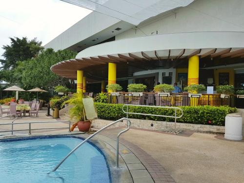 a swimming pool in front of a building at Marco Polo Plaza Cebu in Cebu City
