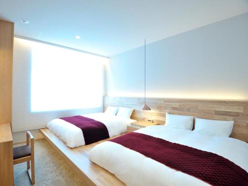 Кровать или кровати в номере hotel androoms Osaka Hommachi