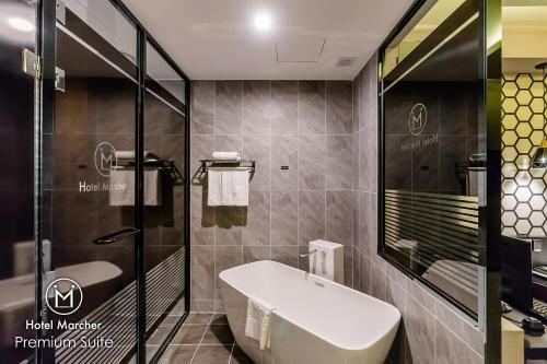 a bathroom with a toilet and a sink and a shower at Hotel Marcher in Busan