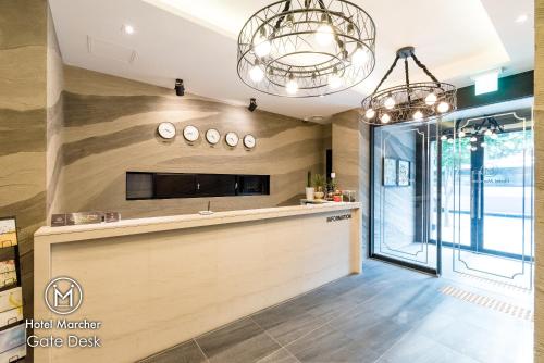 a kitchen with two chandeliers and a counter at Hotel Marcher in Busan