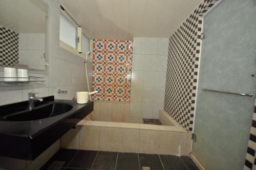 a bathroom with a sink and a shower at 青禾溫泉家民宿 in Jiaoxi