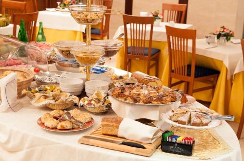 a table with many different types of food on it at Hotel Tiempo in Naples