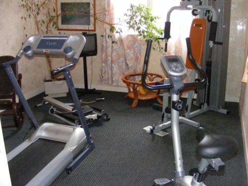a gym with two exercise bikes and a treadmill at Hotel du Commerce in Challans