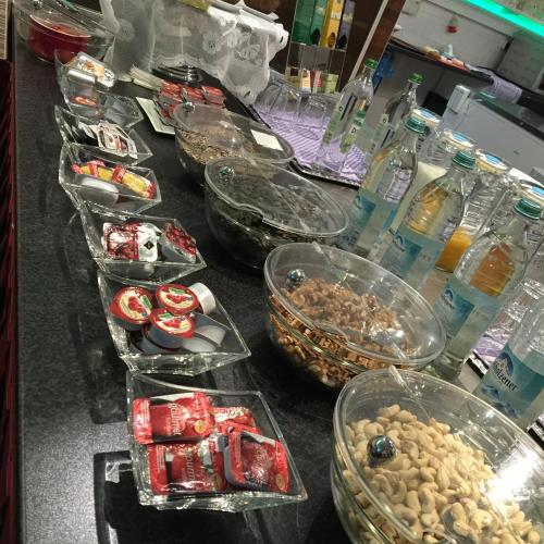 a counter with many plastic containers filled with food at Hotel New Fair Munich Messe in Munich