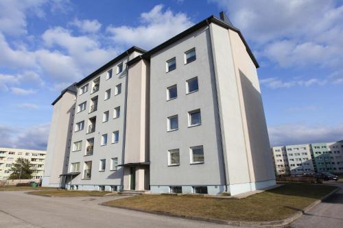 a large white building with aventh floor at Studio apartment in Pärnu