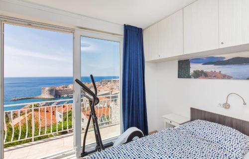 a bedroom with a bed and a large window at Apartment Astelas in Dubrovnik