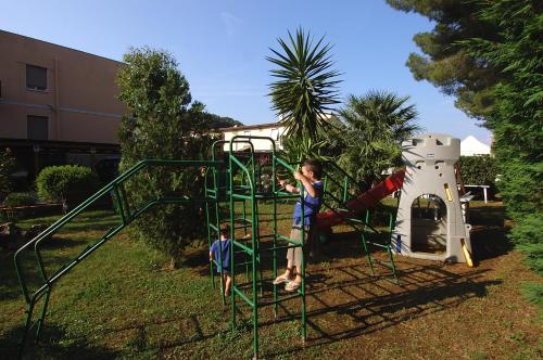 two young boys playing on a playground at Frank's Hotel in Capoliveri