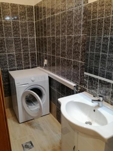 a bathroom with a washing machine and a sink at Apartment Sandra in Umag