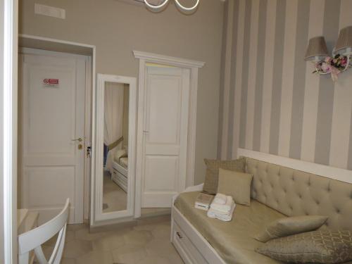 a bedroom with a bed with a mirror and a dressing room at Le Ninfe Luxury Rooms in Naples