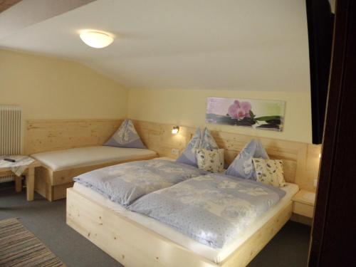 a bedroom with a bed and two tables in it at Haus Rohregger in Mittersill