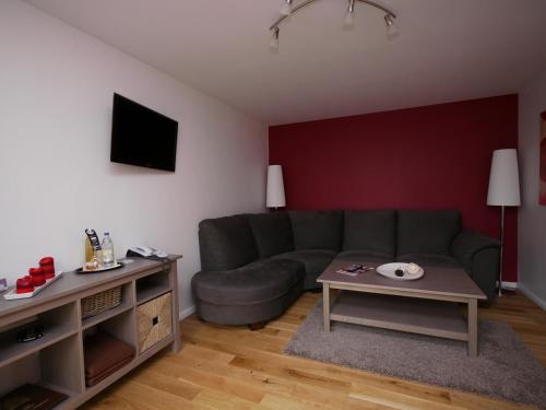 a living room with a couch and a table at Gasthof Oldenwöhrden in Wöhrden
