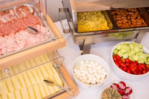 a table topped with lots of different types of food at Villaggio Los Nidos in Lignano Sabbiadoro