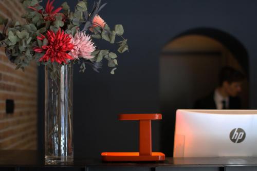 a vase of flowers sitting on top of a table at c-hotels Diplomat in Florence