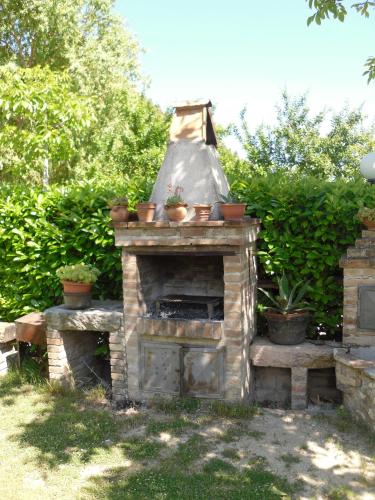 a stone fireplace with potted plants on top of it at Montanari Agrivillage in Narni