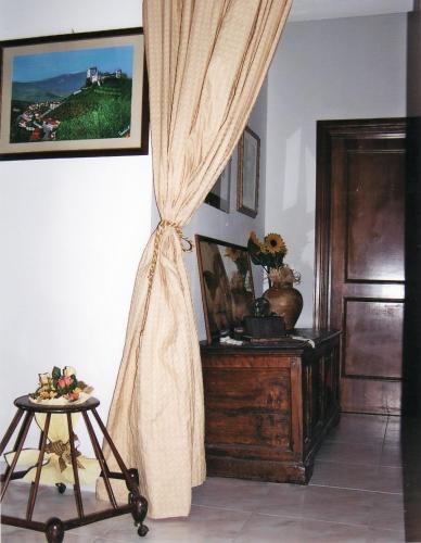 a room with a curtain and a table with a stool at Montanari Agrivillage in Narni