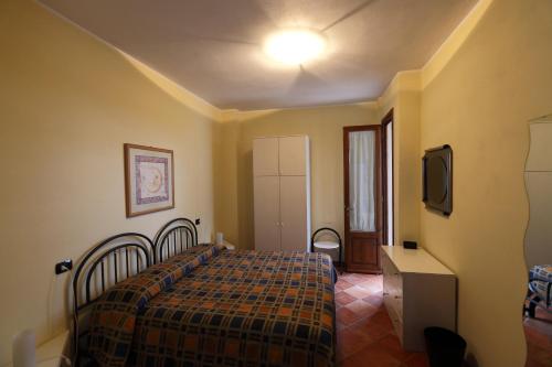 a bedroom with a bed and a tv in it at Casale del Vacanziere in Certaldo