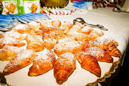 a display of pastries and croissants on a table at Hotel Cristallo in Riolo Terme
