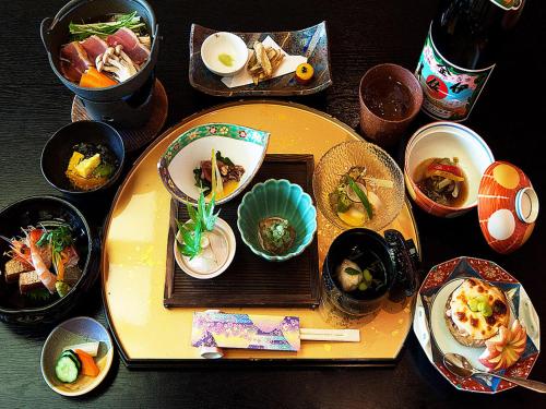a table topped with plates and bowls of food at Kirishima miyama hotel in Kirishima