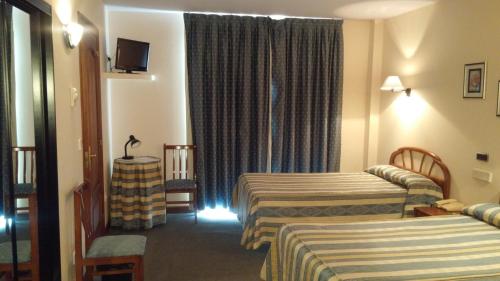 Postel nebo postele na pokoji v ubytování Hotel Zabala