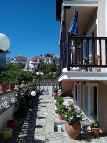 a patio with potted plants on a building at Sofia's Garden by Booking Kottas in Skopelos Town
