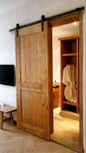 a sliding barn door in a room with a closet at The Twelve Manor•Terraces Lodge in Yuanyang