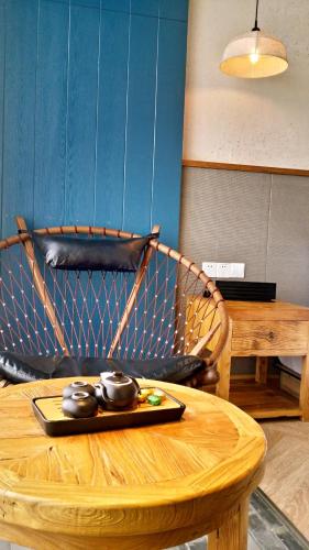 a wooden table with a wooden chair with aucerasteryasteryasteryasteryasteryastery at The Twelve Manor•Terraces Lodge in Yuanyang