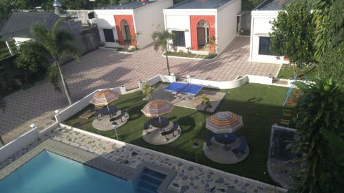 an aerial view of a backyard with a pool and umbrellas at Villa Zam Zam Syariah in Puncak