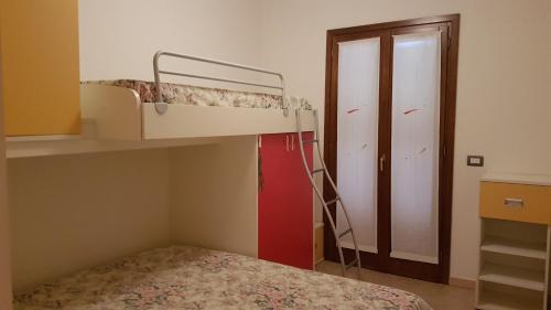a small bedroom with a bunk bed and a ladder at Residenza Lentisco in Castelsardo