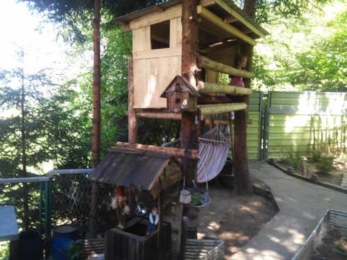 a tree house with a hammock in a yard at Holiday Home Nature Neno in Visoko