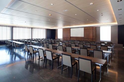 a large room with tables and chairs in it at Hotel AF Pesquera in Peñafiel