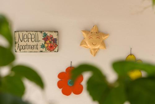 a sign and a star and a flower on a wall at Nikos Hotel in Matala