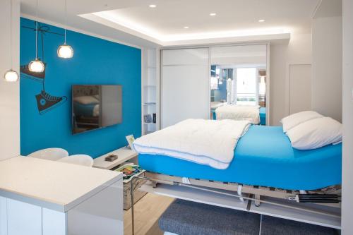 a blue room with a bed and a mirror at Studio Apartment Tia in Makarska