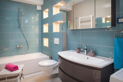 a bathroom with a sink and a toilet and a mirror at Studio Apartment Tia in Makarska