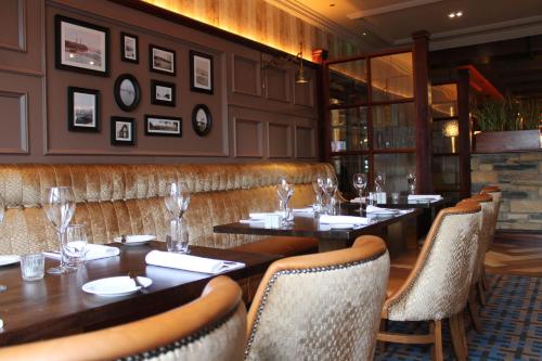 a restaurant with tables and chairs in a room at Abbey Hotel Donegal in Donegal
