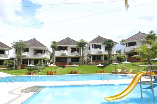 a swimming pool with a slide in front of a resort at Samara Resort in Batu