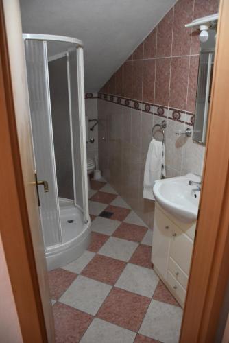 a bathroom with a sink and a shower and a toilet at Guest House Fortuna in Novigrad Istria