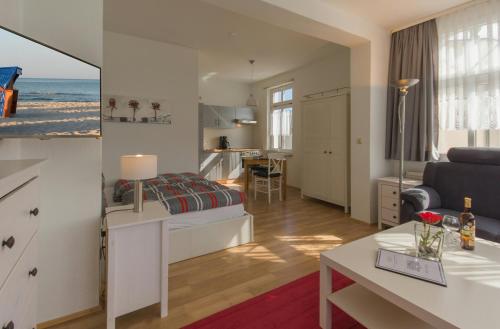 a bedroom with a bed and a living room at Villa Anna in Ostseebad Sellin