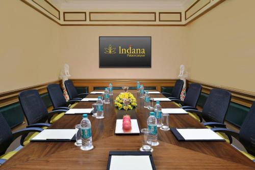 a conference room with a long table and chairs at Indana Palace Jaipur in Jaipur