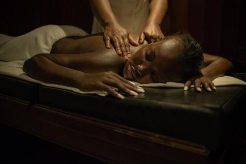 a man getting a massage on a bed at Sarova Stanley in Nairobi