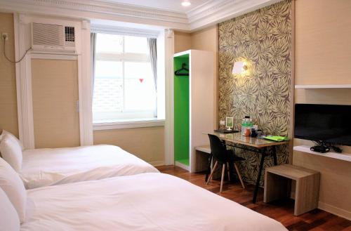 Ένα ή περισσότερα κρεβάτια σε δωμάτιο στο Guest Motel-Zhubei