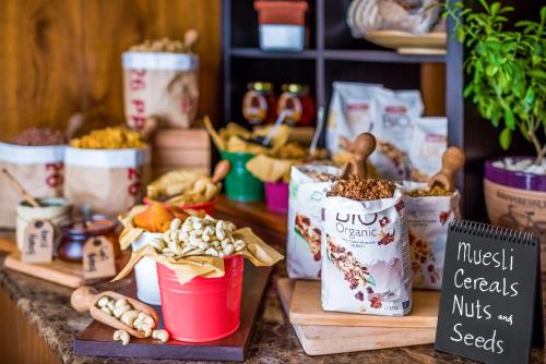a counter topped with buckets of nuts and seeds at SAS Residence & Hotel Dhahran in Al Khobar