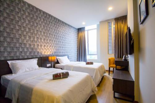 Postel nebo postele na pokoji v ubytování OMG Hotel