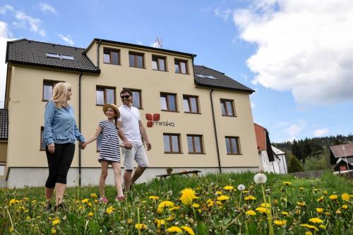 a family standing in front of a house at Miraka in Lipno nad Vltavou