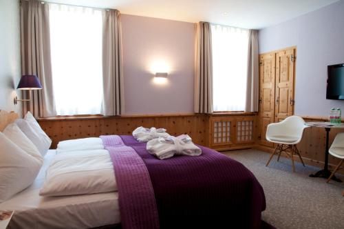 a hotel room with a bed with towels on it at Sleep only in Pontresina