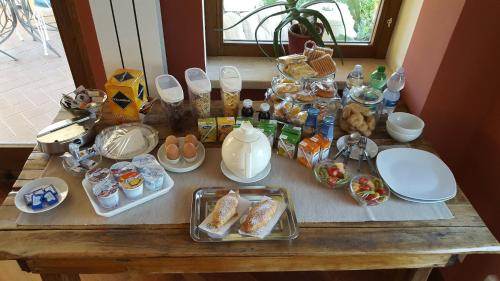 a table topped with plates and bowls of food at Il Nido del Falco in Castel Gandolfo